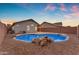 Backyard featuring a sparkling in-ground pool with decorative rocks and low maintenance desert landscaping at 16611 N 19Th St, Phoenix, AZ 85022