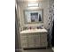 Bathroom with a gray vanity, decorative mirror, and a shower curtain at 18224 N 70Th Ave, Glendale, AZ 85308