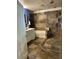 Bathroom featuring stone-look tile, a tub, and a separate shower space at 18224 N 70Th Ave, Glendale, AZ 85308