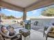 Back patio with wicker seating, ceiling, bar-b-que grill, and a view of the pool at 18556 W Vogel Ave, Goodyear, AZ 85338