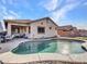 Backyard pool with a patio and rock landscaping, and a view of the home at 18556 W Vogel Ave, Goodyear, AZ 85338