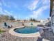 Backyard pool with pebble landscaping and a view of surrounding homes at 18556 W Vogel Ave, Goodyear, AZ 85338