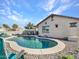 Backyard pool with a patio and rock landscaping, and a view of the home at 18556 W Vogel Ave, Goodyear, AZ 85338