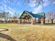 Serene community park featuring a green lawn, stone pavilion, and playground at 18556 W Vogel Ave, Goodyear, AZ 85338