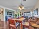 Cozy dining area flows into the living room with a charming light fixture and comfortable seating at 18556 W Vogel Ave, Goodyear, AZ 85338