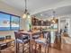 Dining area with natural light transitions into a kitchen with dark cabinets and modern appliances at 18556 W Vogel Ave, Goodyear, AZ 85338