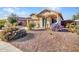 Charming single-story home features desert landscaping and a cozy covered front porch at 18556 W Vogel Ave, Goodyear, AZ 85338