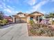 Well-maintained single-story home with desert landscaping and a spacious driveway at 18556 W Vogel Ave, Goodyear, AZ 85338