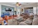 Inviting living area with cozy sofas, a modern fireplace, and ample natural light at 18556 W Vogel Ave, Goodyear, AZ 85338