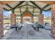 View from inside the stone-columned community pavilion with picnic tables offering a place for gathering at 18556 W Vogel Ave, Goodyear, AZ 85338