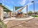 Community playground area with slides and shade structures surrounded by a lush green lawn at 18556 W Vogel Ave, Goodyear, AZ 85338