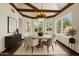 Bright dining room features beamed ceilings, a round table with seating for six, and natural light from the windows at 18845 N 43Rd St, Phoenix, AZ 85050
