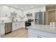 Modern kitchen featuring white cabinetry, stainless steel appliances, granite countertops, and a stylish tile backsplash at 18845 N 43Rd St, Phoenix, AZ 85050
