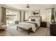 Bright main bedroom boasts ample natural light, a ceiling fan, and a view of the outdoor patio at 18845 N 43Rd St, Phoenix, AZ 85050
