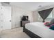 A bedroom with carpeted floors, a gray dresser and a modern gray bed with colorful pillows at 21743 N Daniel Dr, Maricopa, AZ 85138