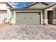 Well maintained green two-car garage with desert landscaping for low maintenance curb appeal at 21743 N Daniel Dr, Maricopa, AZ 85138