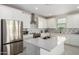 Bright, modern kitchen with stainless steel appliances, a large island, and white cabinetry at 21743 N Daniel Dr, Maricopa, AZ 85138