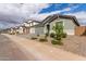 Attractive street view showcasing well-maintained homes with desert landscaping, creating a welcoming neighborhood appeal at 21743 N Daniel Dr, Maricopa, AZ 85138