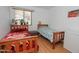 Bedroom with twin beds, wood frames, bright window and laminate flooring at 2201 W Wethersfield Rd, Phoenix, AZ 85029