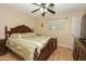 Spacious bedroom features a ceiling fan, window, and a large bed with detailed wooden frame at 2201 W Wethersfield Rd, Phoenix, AZ 85029