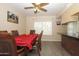 Traditional dining room with elegant wooden furniture, ceiling fan, and gray floors at 2201 W Wethersfield Rd, Phoenix, AZ 85029