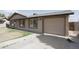 Single-story house with a well-kept lawn, a two-car garage, and neutral exterior paint at 2201 W Wethersfield Rd, Phoenix, AZ 85029