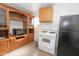 Laundry space featuring modern appliances with cabinets and oven range, maximizing efficiency and organization at 2201 W Wethersfield Rd, Phoenix, AZ 85029