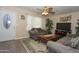 Spacious living room offers a white front door, neutral walls, ceiling fan, and tile floors at 2201 W Wethersfield Rd, Phoenix, AZ 85029