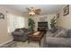 Inviting living room with cozy sofas, ceiling fan, and neutral color palette at 2201 W Wethersfield Rd, Phoenix, AZ 85029