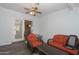 Bright sunroom has brick accent wall, gray floors, and orange wicker furniture at 2201 W Wethersfield Rd, Phoenix, AZ 85029