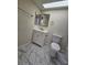 This spacious bathroom features marble floors, a white vanity, and a modern toilet at 2255 W Bloomfield Rd, Phoenix, AZ 85029