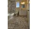 Well-lit bathroom featuring marble tile, a shower over tub, and white vanity at 2255 W Bloomfield Rd, Phoenix, AZ 85029