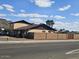 Street view of a two-story home with block perimeter fence and desert landscaping at 2255 W Bloomfield Rd, Phoenix, AZ 85029