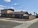 Tan two-story home with a gravel yard and desert landscaping plus a tall brick fence along the perimeter at 2255 W Bloomfield Rd, Phoenix, AZ 85029