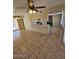 Open-concept living room showcasing tile floors, modern lighting, and a kitchen bar area at 2255 W Bloomfield Rd, Phoenix, AZ 85029