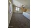 Bright living room featuring neutral-toned walls, carpeted floors, and a ceiling fan at 2255 W Bloomfield Rd, Phoenix, AZ 85029