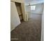 The loft has carpeted floors and a window that looks out to the neighborhood and a closet at 2255 W Bloomfield Rd, Phoenix, AZ 85029