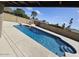 Sparkling in-ground pool, diving board, and water feature enhance the backyard oasis at 2255 W Bloomfield Rd, Phoenix, AZ 85029