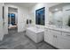 Bright bathroom with tub, double sinks and modern neutral color palette at 23880 N 127Th St, Scottsdale, AZ 85255