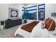 This bedroom features large windows, a decorative rug, and a statement art piece at 23880 N 127Th St, Scottsdale, AZ 85255