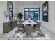 Elegant dining room with a large window, contemporary lighting, and stylish seating for eight at 23880 N 127Th St, Scottsdale, AZ 85255