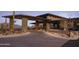 Impressive building entrance featuring stone columns, modern lighting, and desert landscaping at 23880 N 127Th St, Scottsdale, AZ 85255