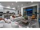 Open-concept living room connecting to the kitchen, featuring comfortable seating and a modern design at 23880 N 127Th St, Scottsdale, AZ 85255