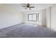 Serene bedroom boasts a large bay window providing natural light, complete with neutral carpeting and a ceiling fan at 2455 E Broadway Rd # 102, Mesa, AZ 85204