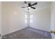 Cozy bedroom with neutral walls, new carpeting, corner windows and a ceiling fan at 2455 E Broadway Rd # 102, Mesa, AZ 85204