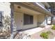 Front porch with tan siding, a white security door, and manicured gravel landscaping at 2455 E Broadway Rd # 102, Mesa, AZ 85204