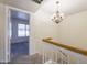 Hallway featuring a charming chandelier and a view into a sunlit room at 2455 E Broadway Rd # 102, Mesa, AZ 85204