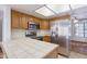 Bright kitchen showcasing tile countertops, stainless steel appliances, and ample wooden cabinet space at 2455 E Broadway Rd # 102, Mesa, AZ 85204