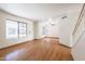 Bright living room with hardwood floors, large windows, and a white staircase at 2455 E Broadway Rd # 102, Mesa, AZ 85204