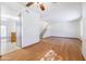 Bright living room featuring hardwood floors, a ceiling fan, and stairs leading to the upper level at 2455 E Broadway Rd # 102, Mesa, AZ 85204